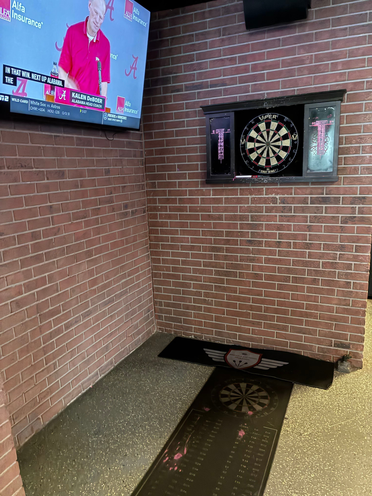 The dartboard on the brick wall