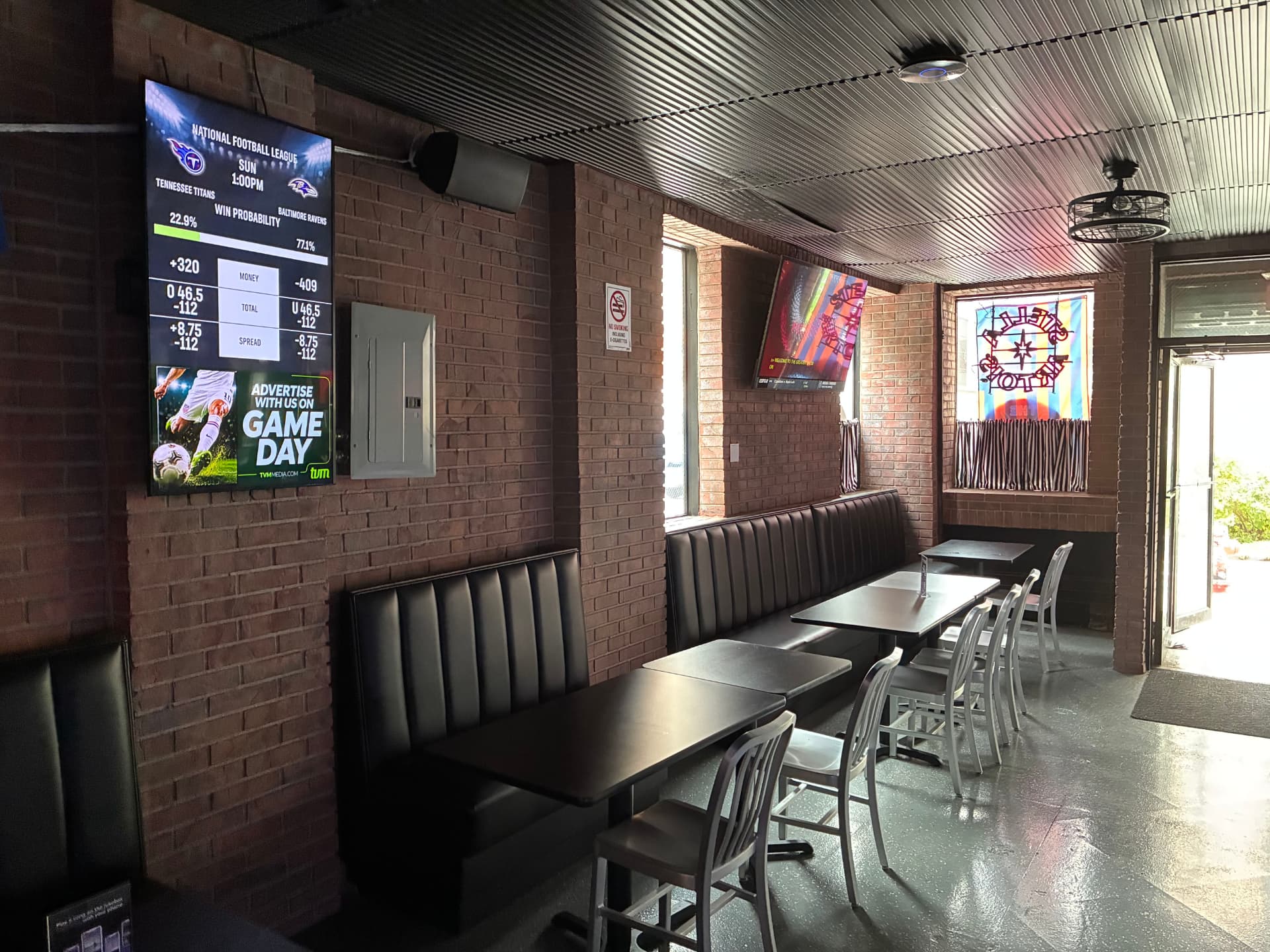 Booth seating beneath the TVs